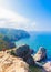 View of Woman relaxing on rocky cliff Cabo da Roca, Portugal