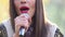 View of woman\'s mouth with red lipstick, smiling and singing with microphone