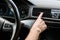 View of woman touching air conditioner switch in car