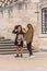 View of women close to the staircase of the University of Law building in Coimbra, speaking and taking pictures with the mobile