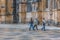 View of women tourists walking on exterior close to the Gothic exterior facade of the Monastery of Batalha, Mosteiro da Batalha,