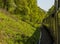 A view of the wooded banks from a steam train on a railway in the UK