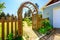 View of Wooden arbor. Arched entry to the garden.