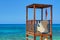 View on wooden beach rescue man place house cabin tower lifeguard on blue sea sand. Rescuer loge chair and flag. Mediterranean Sea