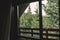 View from wooden cabin window on trees, woods and mountains. Space for text. Travel and vacations. Relaxing in log in forest