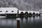 View of wooden cabins near the lake during winter