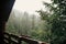 View from wooden cottage porch on rainy woods in mountains. mist