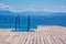 View of wooden pier with blue bathing ladder