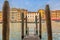 View from a wooden pier onto buildings along Grand Canal of Venice Italy