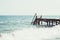 View of a wooden pier and seascape with running waves