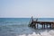 View of a wooden pier and seascape with running waves