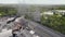 a view of a working factory from a drone with a black house overlooking