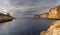 view of the Xlendi Bay watchtower and cliffs on the coast of Gozo Island in Malta