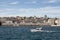 View of a yacht on Bosphorus passing in front of newly developed port in Istanbul. Beyoglu district is in the view.