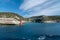 View from the yacht to the lighthouse, rocks. Blue sky with small clouds