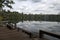 View of Yeak Lom lake from wooden pier with reflection of sky in water