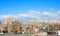 View of Yerevan in spring. Leningradyan street: buildings from tuff, road and cars in sunny day