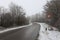 View of yield sign on a dangerous stretch of road on a foggy winter morning