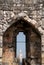 View of York Cathedral through the arrow slit at the top of historic Clifford`s Tower, England UK