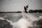 view of young athlete guy doing an extreme jump on wakeboard