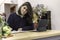 View of a young female florist running a flower shop business and scheduling the agenda in front of a laptop. Businesswoman