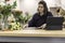 View of a young female florist running a flower shop business and scheduling the agenda in front of a laptop. Businesswoman