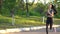 View on young woman are exercising with outdoor running in the city park.