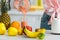 View of young woman pouring delicious smoothie in glass