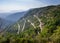 View of zigzag mountain road with hairpin bends in the Apuan Alps, Alpi Apuane, near the Vestito Pass. Above Massa