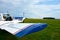 View of Zlin 43 aerobatic sport plane standing at airport. Grass and blue sky