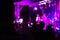 The viewer shoots a rock concert on a smartphone. Bright scene with lights. The focus is blurred