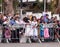 Viewers from behind dividing fence look at the carnival parade