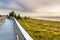 Viewing footbridge over the dunes overlooking the Baltic Sea at sunset, dunes covered with grass