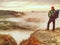 Viewpoint above misty clouds in rocks. Enchanted autumn landscap