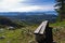 Viewpoint with a bench at mount Bobija, beautiful view of surrounding peaks, hills, meadows and colorful forests