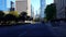 Viewpoint of Downtown City People and Traffic Along Street Surrounded by Tall Buildings in Summer Day.  Urban Cityscape of Road