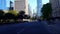 Viewpoint of Downtown City People and Traffic Along Street Surrounded by Tall Buildings in Summer Day.  Urban Cityscape of Road