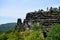 Viewpoint on a sandstone rock against a backdrop of green pine forest and blue clear sky in National Park Czech Switzerland