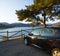 Viewpoint at sunset. Car parked in front of Water and Mountains Landscape