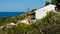 Viewpoint from white appartment houses surrounded by greenery at the coast of Skopelos island near Panormos bay