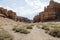 Views within the Charyn Canyon to the reddish sandstone cliffs