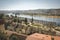 Views of the city of Coimbra Portugal from the hill to the river, bridge, park and historic buildings. City landscape in spring