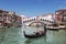 Views of the Grand canal, gondola with tourists and the Rialto bridge. Venice