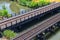 Views of Jordan River Trail Pedestrian and Train Track Bridge with surrounding trees, Russian Olive, cottonwood and muddy stream a