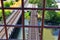 Views of Jordan River Trail Pedestrian and Train Track Bridge with surrounding trees, Russian Olive, cottonwood and muddy stream a