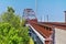 Views of Jordan River Trail Pedestrian and Train Track Bridge with surrounding trees, Russian Olive, cottonwood and muddy stream a