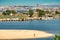 views of lisbon from Barreiro.  in the foreground human figure moving on the sand.