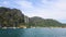 Views of the mountains, tropical island, port and speedboats and boats passing by. shooting from water.