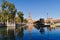 Views of the Seville Plaza de Espana from the side, where the main tower is reflected in the water