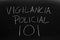 Vigilancia Policial 101 On A Blackboard.  Translation: Policing 101